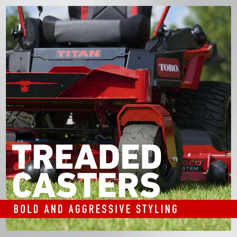 Red Toro lawn mower with treaded casters on grass